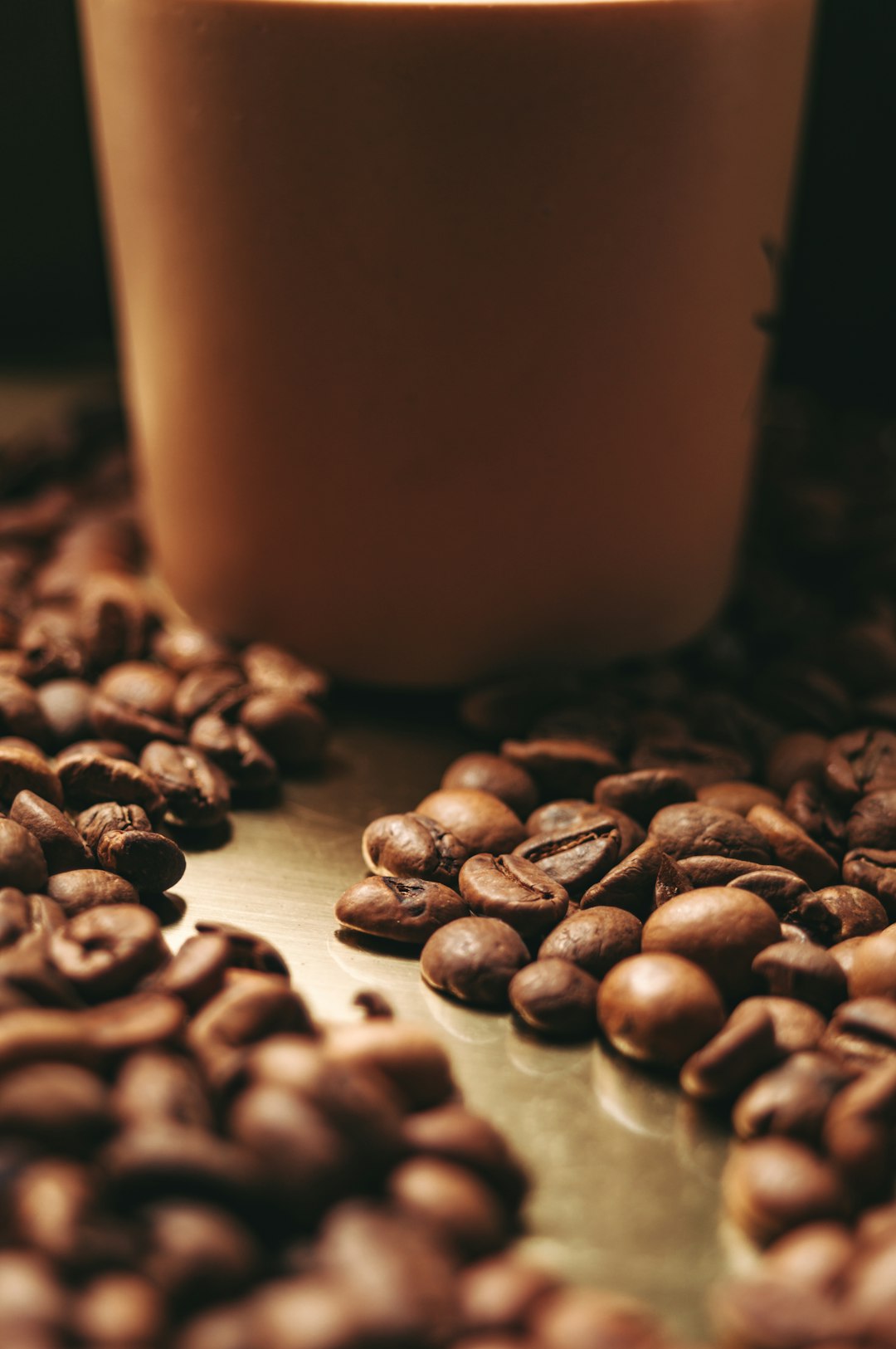 a-cup-of-coffee-sitting-on-top-of-a-pile-of-coffee-beans-z4aiyhseeli